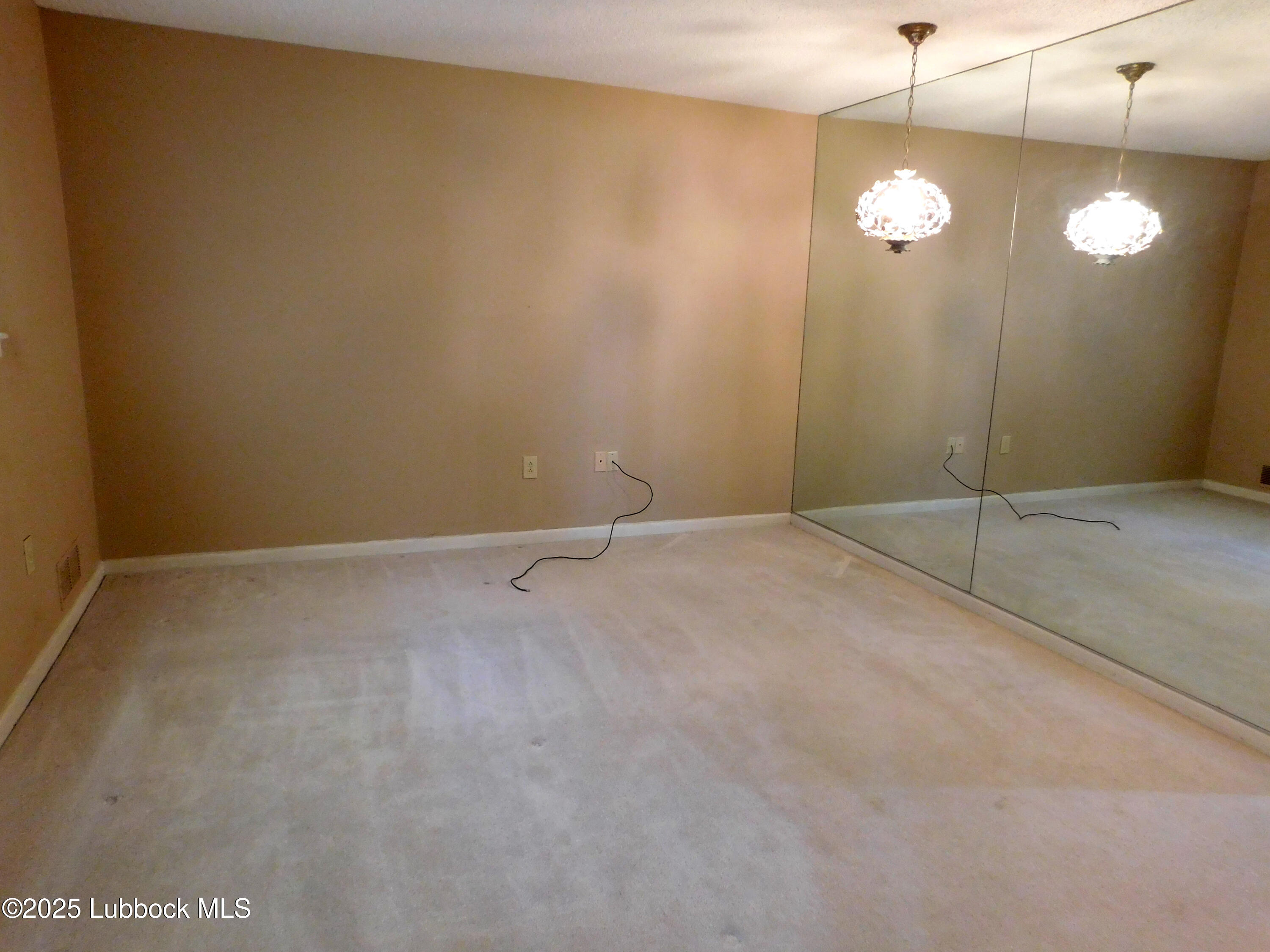 1925 Highway 70 Muleshoe, TX 79347 - Photo 31 of 49 a view of an empty room with a chandelier fan