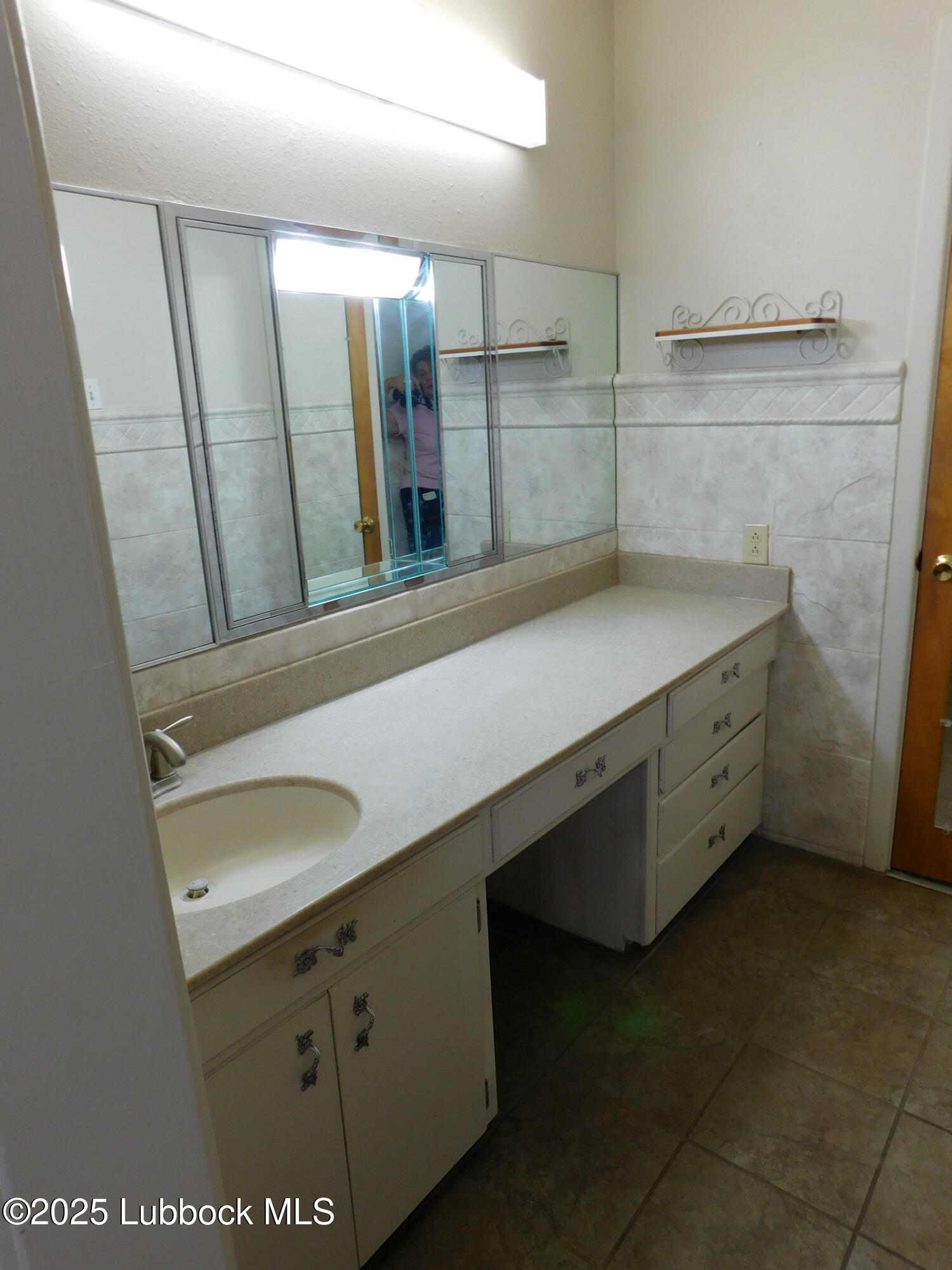 1925 Highway 70 Muleshoe, TX 79347 - Photo 38 of 49 a bathroom with a sink and a mirror