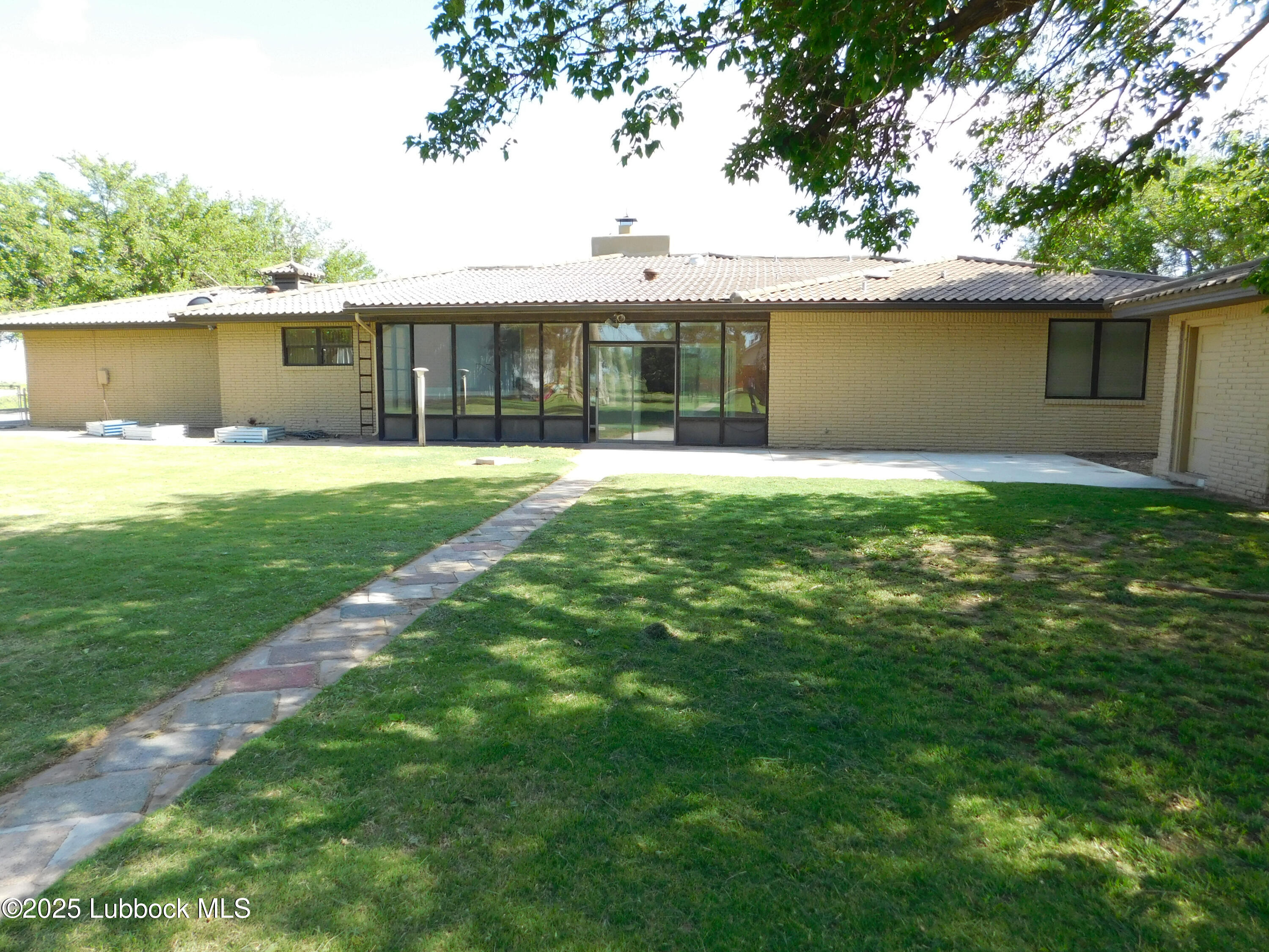 1925 Highway 70 Muleshoe, TX 79347 - Photo 43 of 49 a front view of a house with a yard and trees