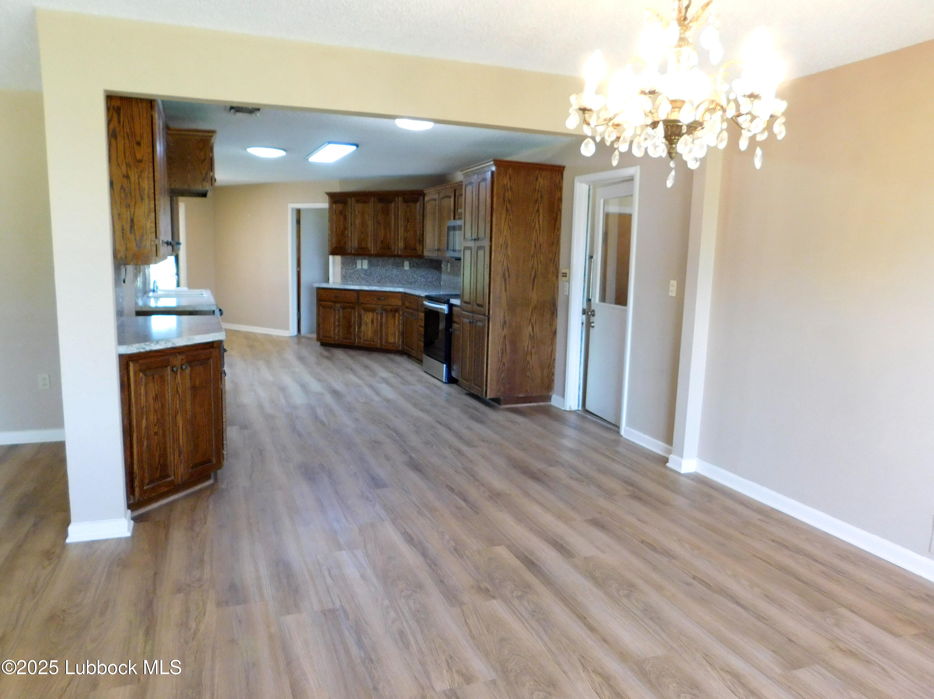1925 Highway 70 Muleshoe, TX 79347 - Photo 8 of 49 a view of a kitchen with granite countertop cabinets and chandelier