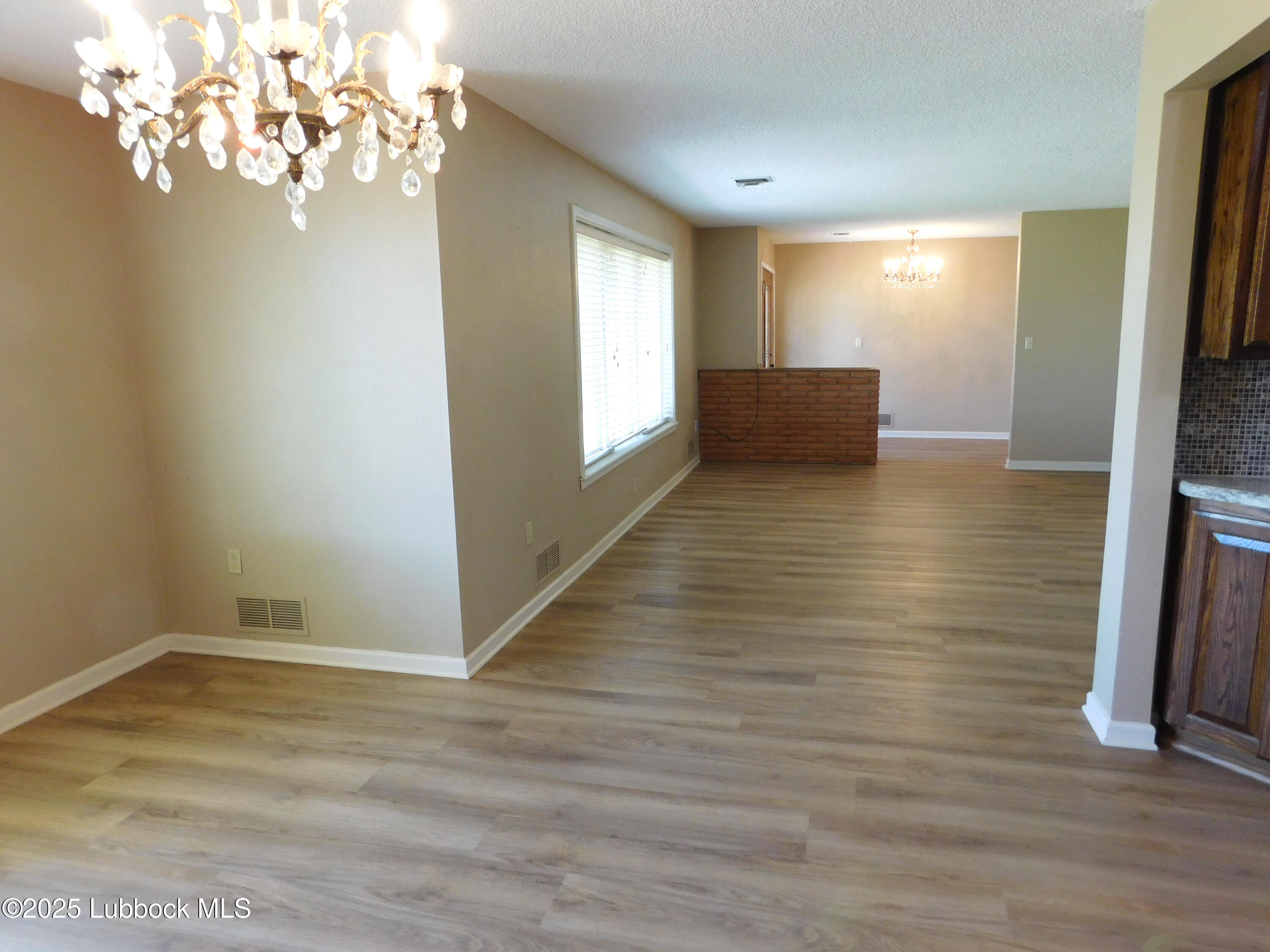 1925 Highway 70 Muleshoe, TX 79347 - Photo 9 of 49 a view of empty room with wooden floor and fan