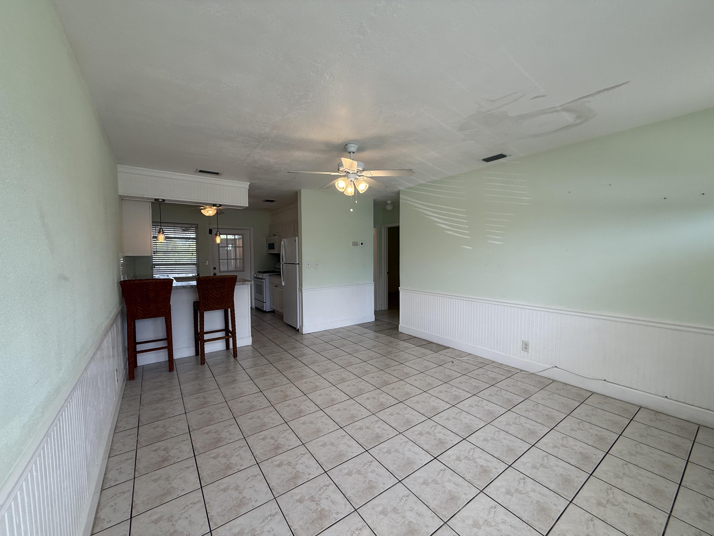 3962-3964 No Name Road Big Pine Key, FL 33043 - Photo 11 of 26 a view of a livingroom and a kitchen with furniture and chandelier