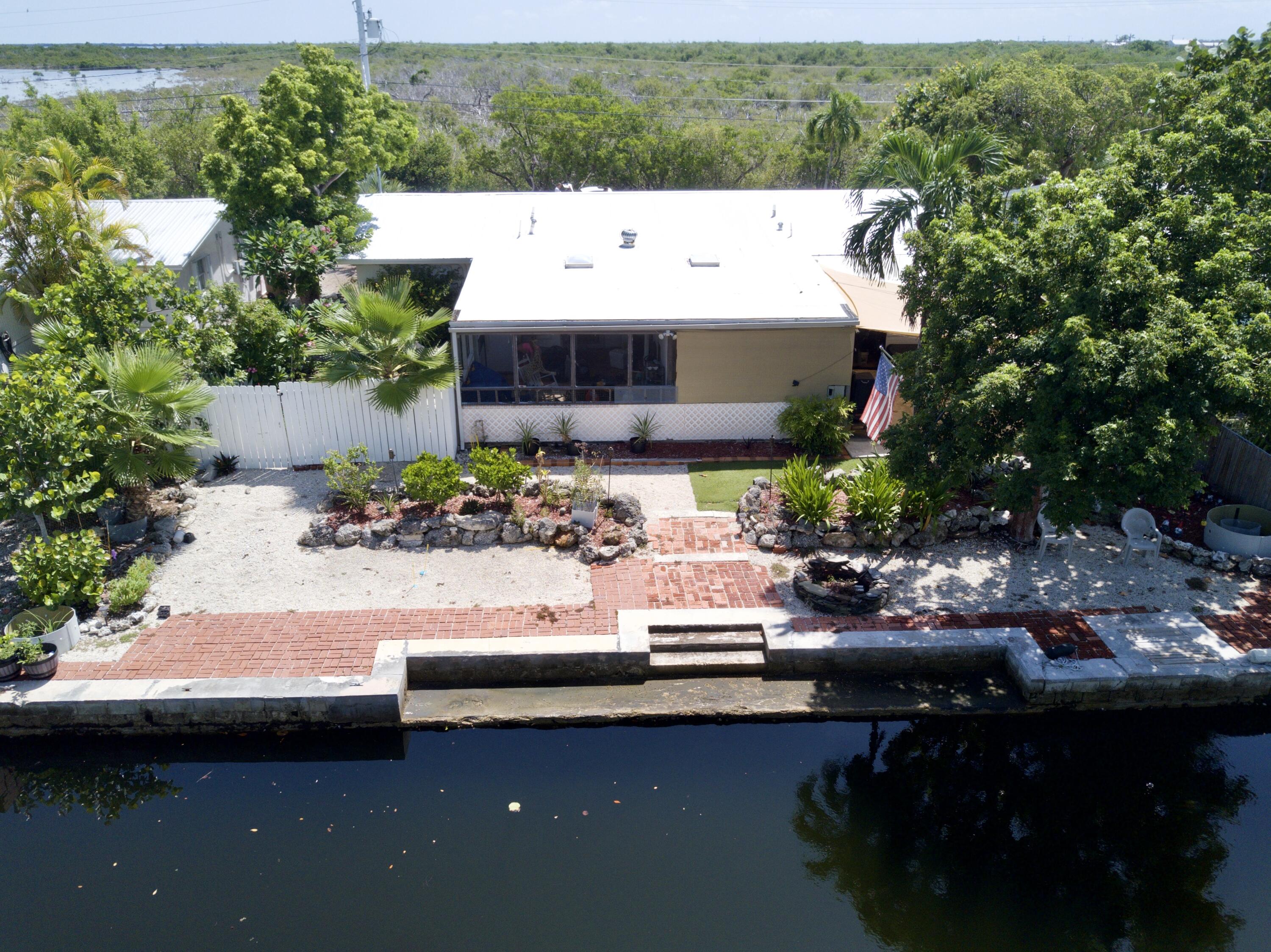 3962-3964 No Name Road Big Pine Key, FL 33043 - Photo 2 of 26 a view of a house with yard and sitting area