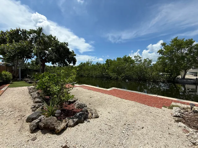 a view of a yard with wooden fence