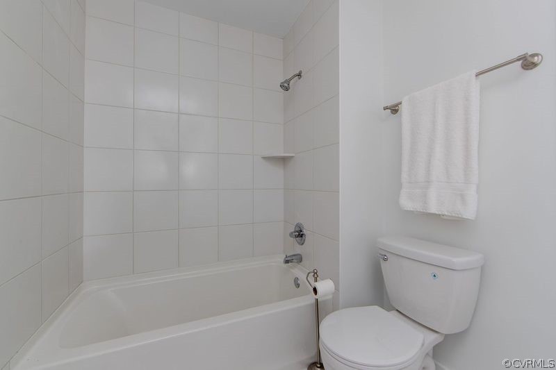 13603 Timber Ridge Court Midlothian, VA 23112 - Photo 22 of 29 a white toilet and tub sitting next to a white cabinet