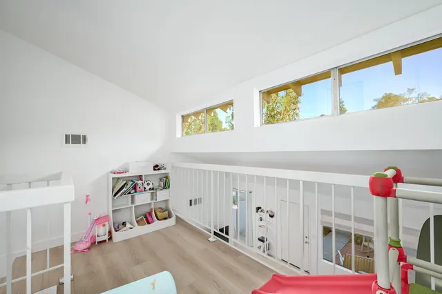 a view of a patio with table and chairs and wooden fence
