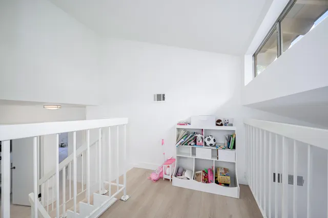 a view of a patio with couches table and chairs and potted plants