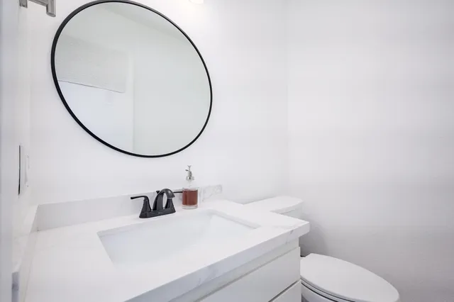a view of a chairs and table in the back yard of the house