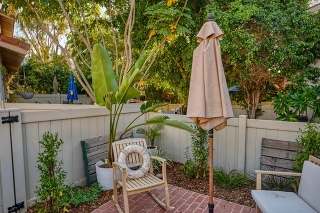 a front view of a house with a yard and mountain view