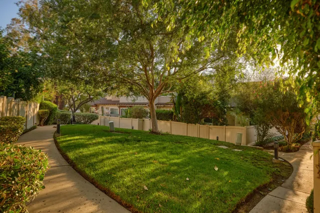 an aerial view of a house with a yard and lake view