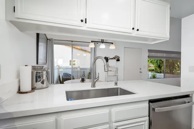 a kitchen with a sink and a large window