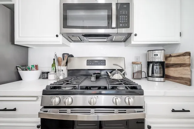 a stove top oven sitting inside of a kitchen