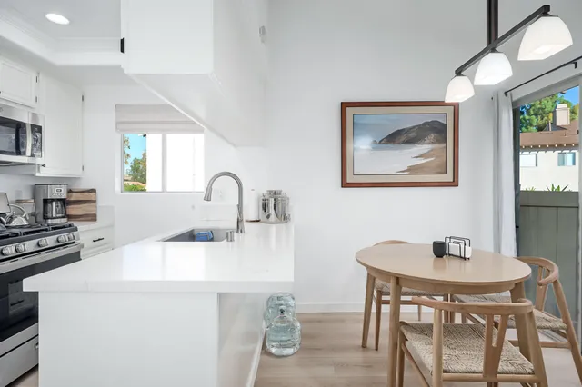 a kitchen with a dining table and chairs