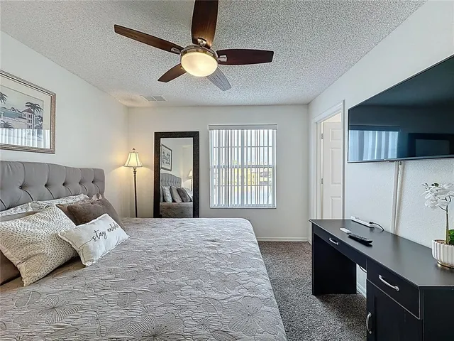 a bedroom with bed and a large mirror