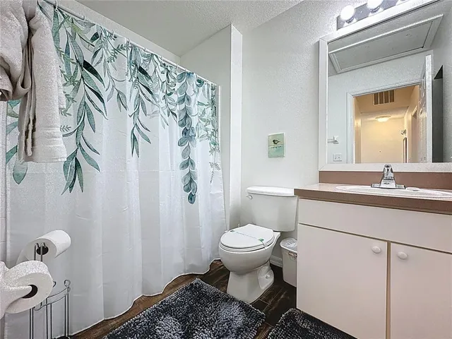 a bedroom with a bed tv and a window