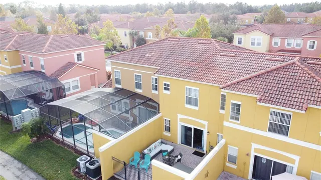 an aerial view of residential houses with outdoor space and river