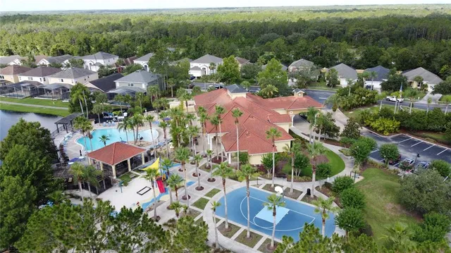 an aerial view of residential houses with outdoor space and lake view