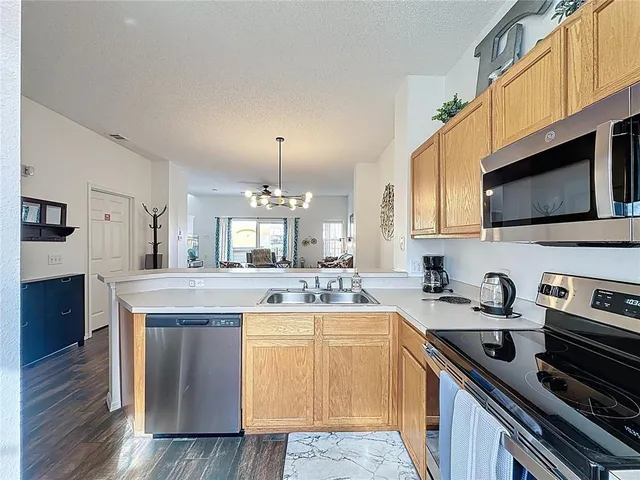 a kitchen with a sink stove and cabinets