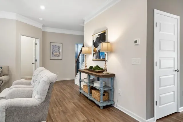 a living room with furniture and a wooden floor