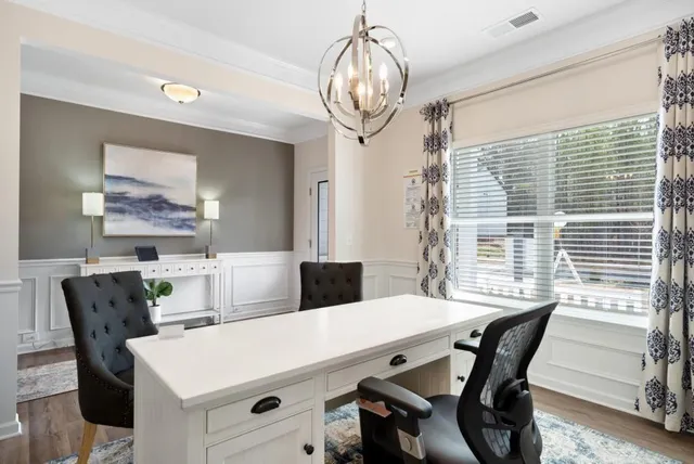 a view of a dining room with furniture window and wooden floor