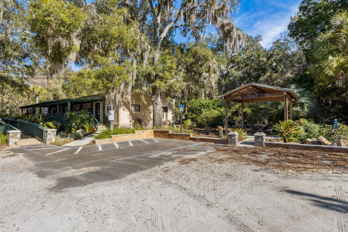 a view of a patio with a table and chairs under an umbrella