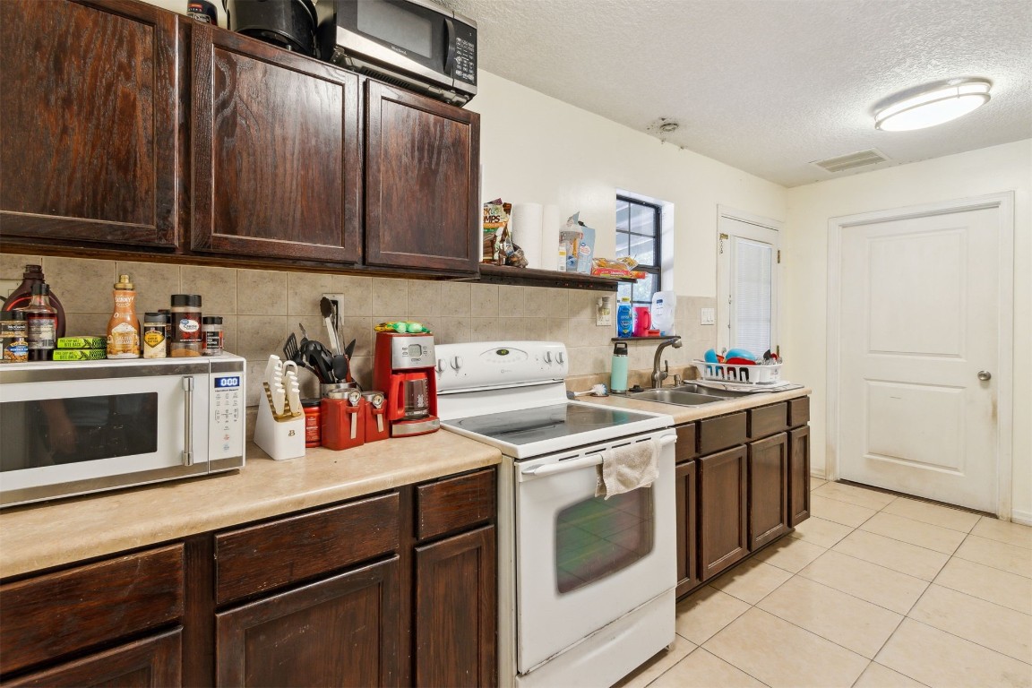 850310 Us Highway Yulee, FL 32097 - Photo 7 of 13 a kitchen with a sink stove and cabinets