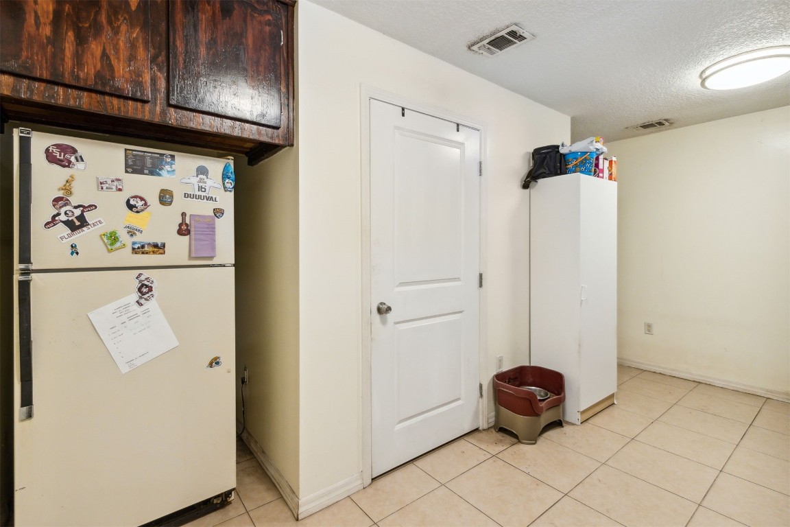 850310 Us Highway Yulee, FL 32097 - Photo 8 of 13 a room with a refrigerator and cabinets
