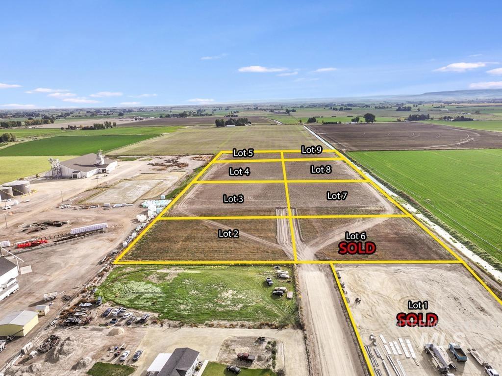 Aerial view of sparsely populated area with property parcel outlined