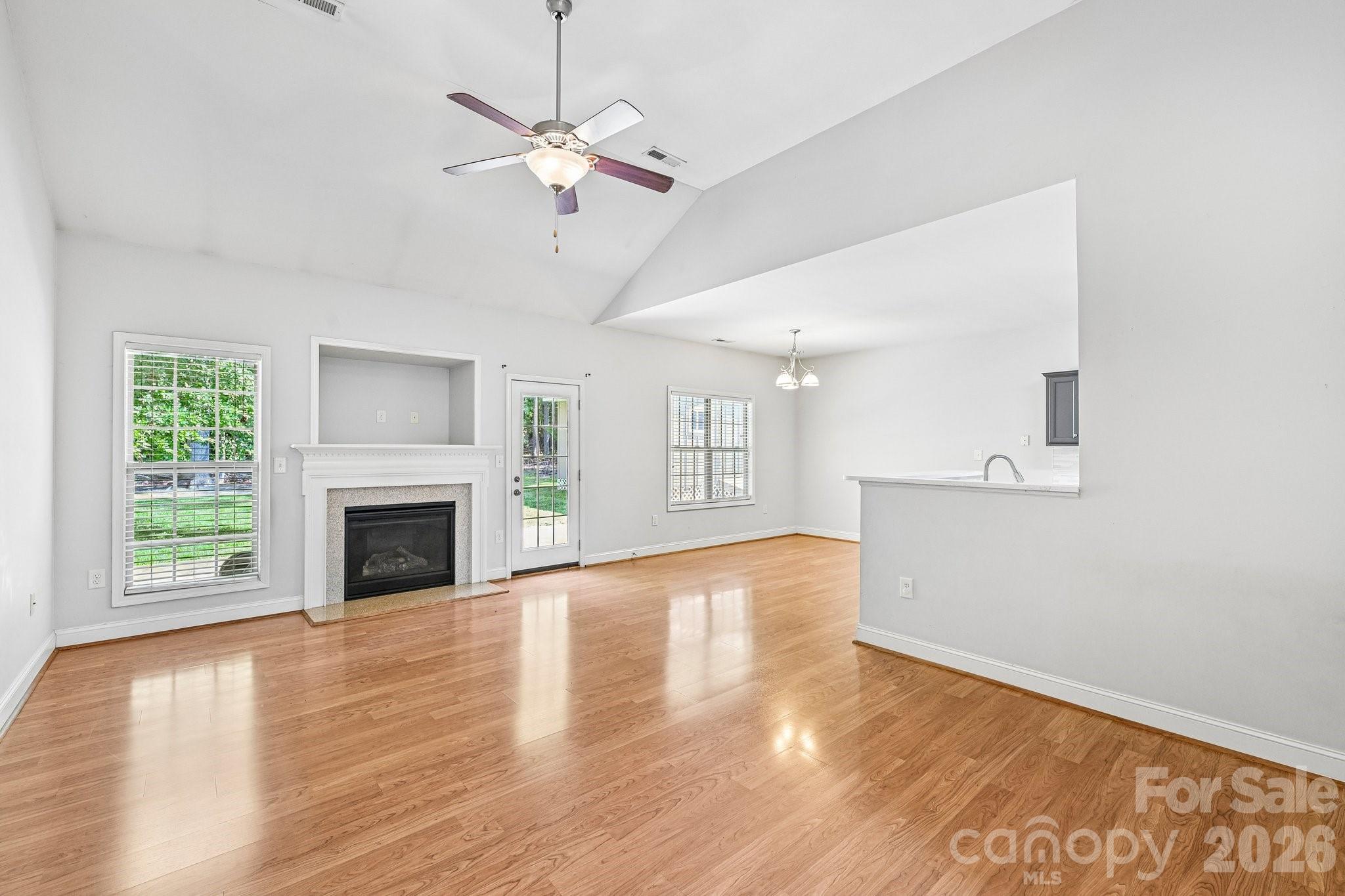 624 Hunley Street Monroe, NC 28112 - Photo 8 of 36 a view of an empty room with wooden floor and a window