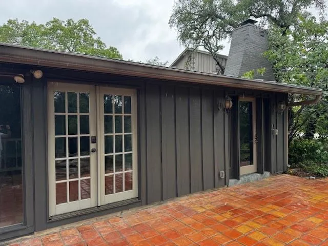 a view of a black house with a large window