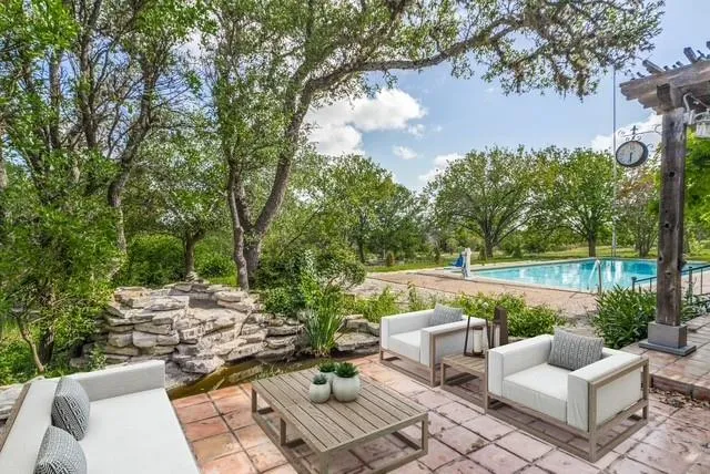 a view of a patio with couches under an umbrella