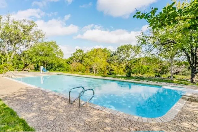 a view of a swimming pool with a yard