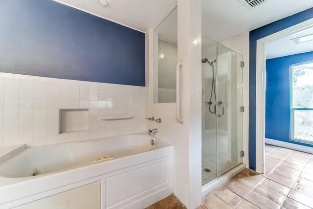 a bathroom with a bathtub and a shower