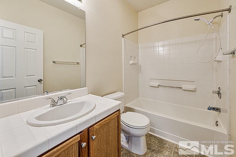 1137 Tule Drive Reno, NV 89521 - Photo 13 of 17 a bathroom with a sink a toilet and a bathtub