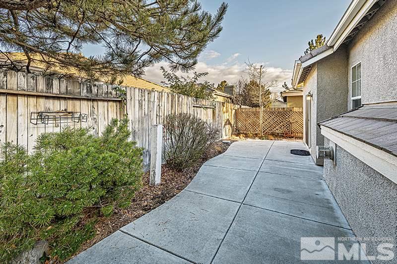 1137 Tule Drive Reno, NV 89521 - Photo 15 of 17 a pathway of a house with a yard