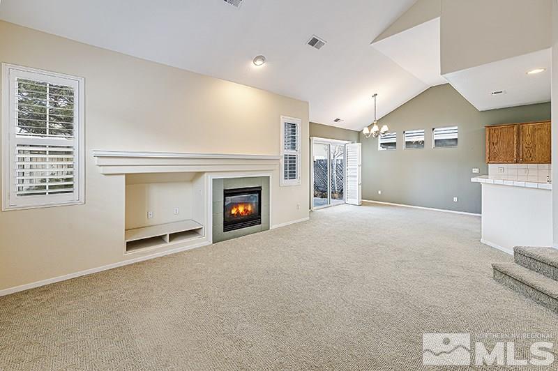 1137 Tule Drive Reno, NV 89521 - Photo 3 of 17 a view of empty room with a fireplace and fan