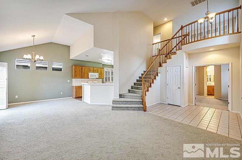 1137 Tule Drive Reno, NV 89521 - Photo 4 of 17 a view of a living room with wooden floor and stairs