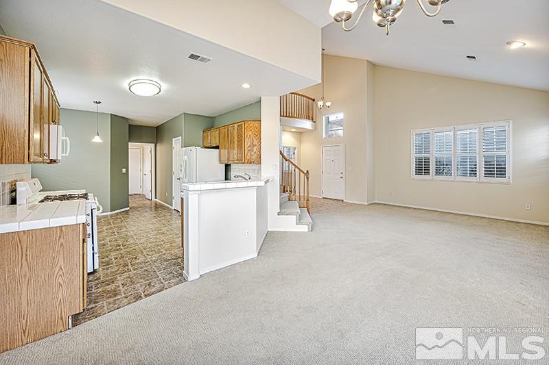 1137 Tule Drive Reno, NV 89521 - Photo 5 of 17 a view of a kitchen with a sink dishwasher stove and refrigerator