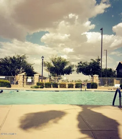 a view of a ocean with boats and trees in the background
