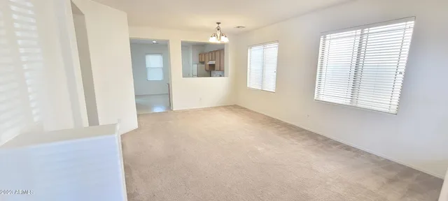 an empty room with windows and entrance