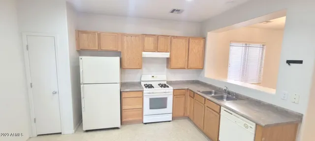 a kitchen with a stove top oven sink and cabinets