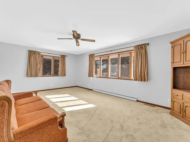 a view of a yard with plants and a bench