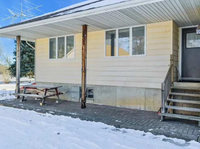 a kitchen with granite countertop a stove top oven a sink dishwasher and cabinets with wooden floor