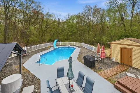 a view of backyard of house with seating space
