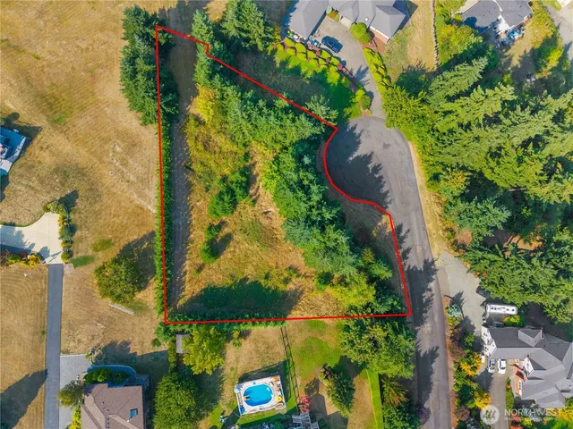 an aerial view of a house with a yard and garden