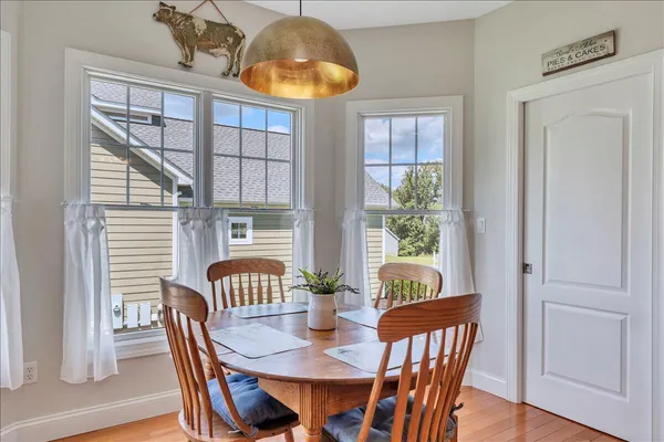 a view of a dining room with furniture window and wooden floor