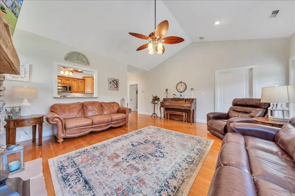 a bedroom with furniture and a wooden floor