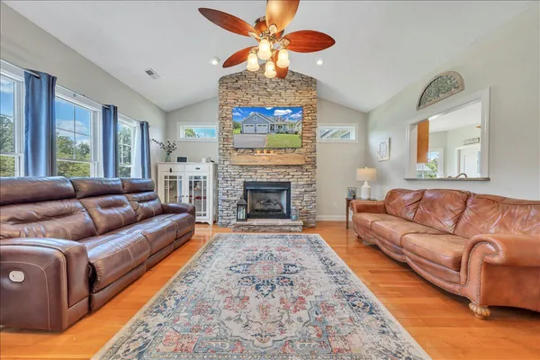 a living room with furniture a fireplace and a chandelier