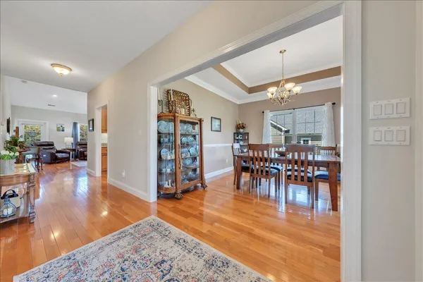 a view of a dining room with furniture and a chandelier