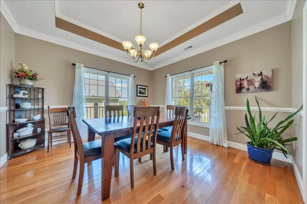 a view of a dining room with furniture window and wooden floor